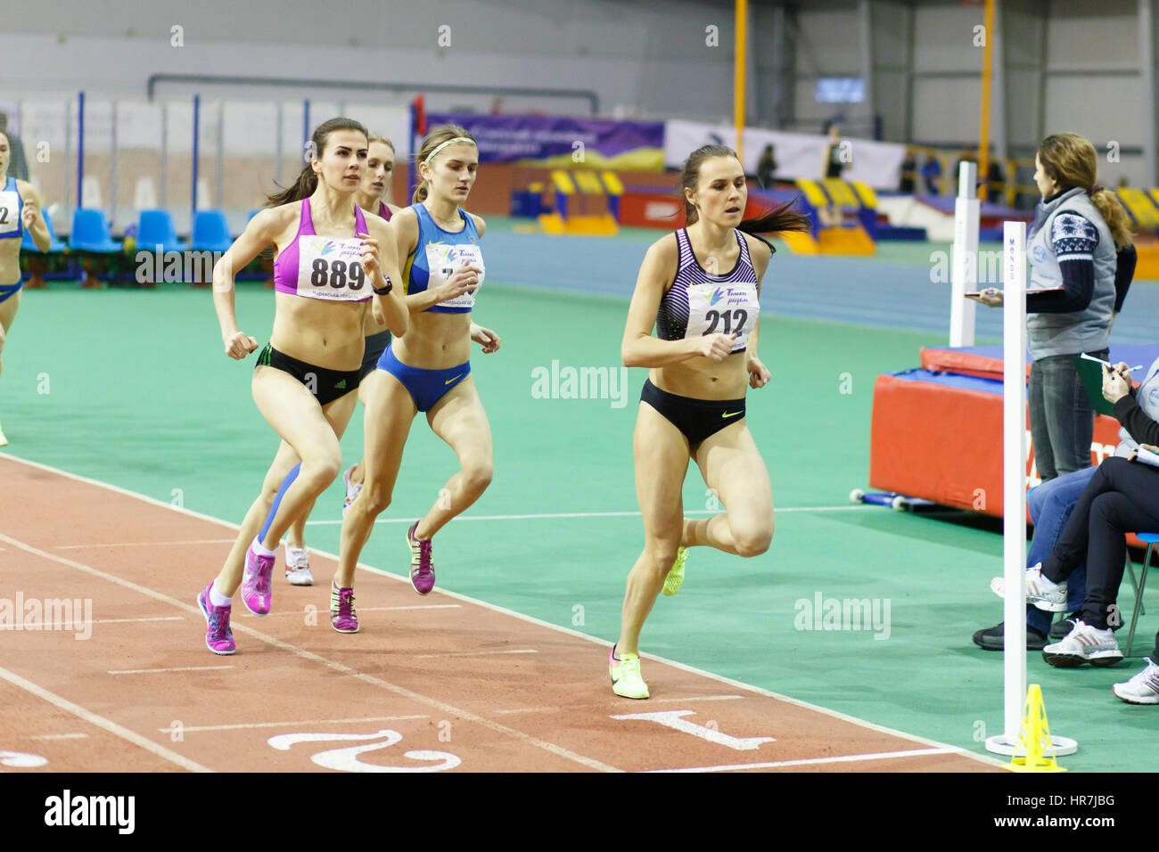 SUMY, UKRAINE - FEBRUARY 17, 2017: Mariya Shatalova (212), Olena Sokur (889), Viktoria Khapilina (662) and Nataliia Strebkova (749) running in final of 3000m race on Ukrainian indoor track and field championship 2017 Stock Photo