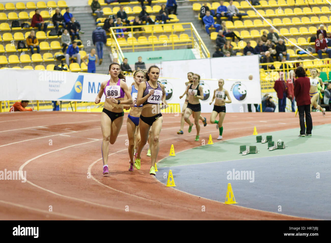 SUMY, UKRAINE - FEBRUARY 17, 2017: Mariya Shatalova (212) and Olena Sokur (889) with other sportswomen running in final of 3000m race on Ukrainian indoor track and field championship 2017 Stock Photo