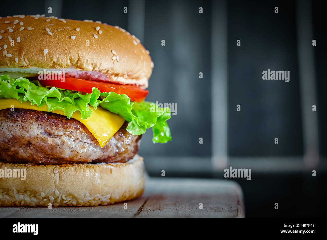 Tasty grilled beef Burger on wood background Stock Photo