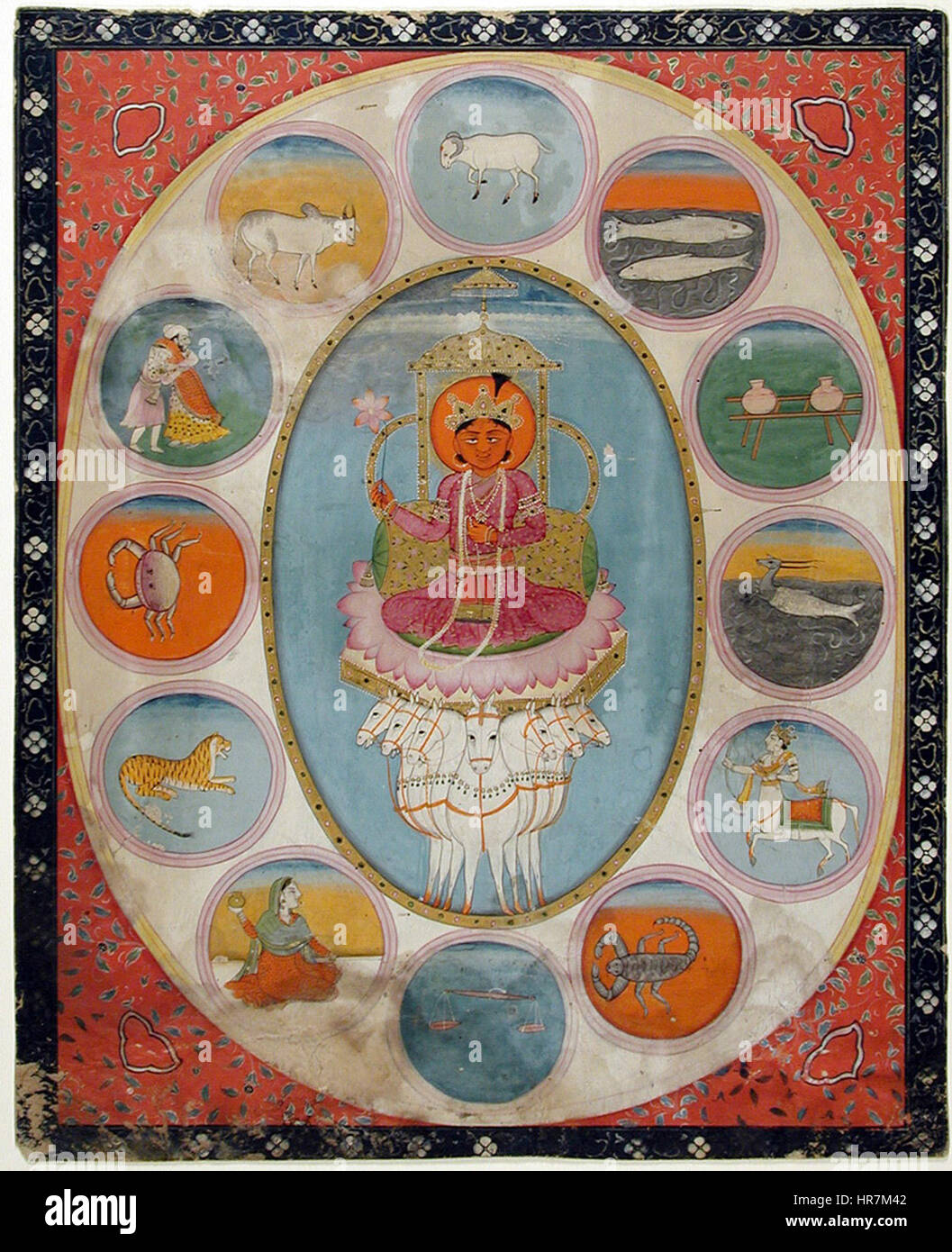 'Surya Surrounded by the Signs of the Zodiac' depicts the sun god Surya in Hindu mythology, surrounded by the twelve zodiac signs. This artwork represents the intersection of Hindu iconography and astrology. Stock Photo