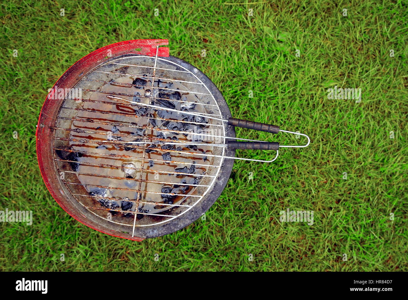 A used barbecue full of rain water Stock Photo