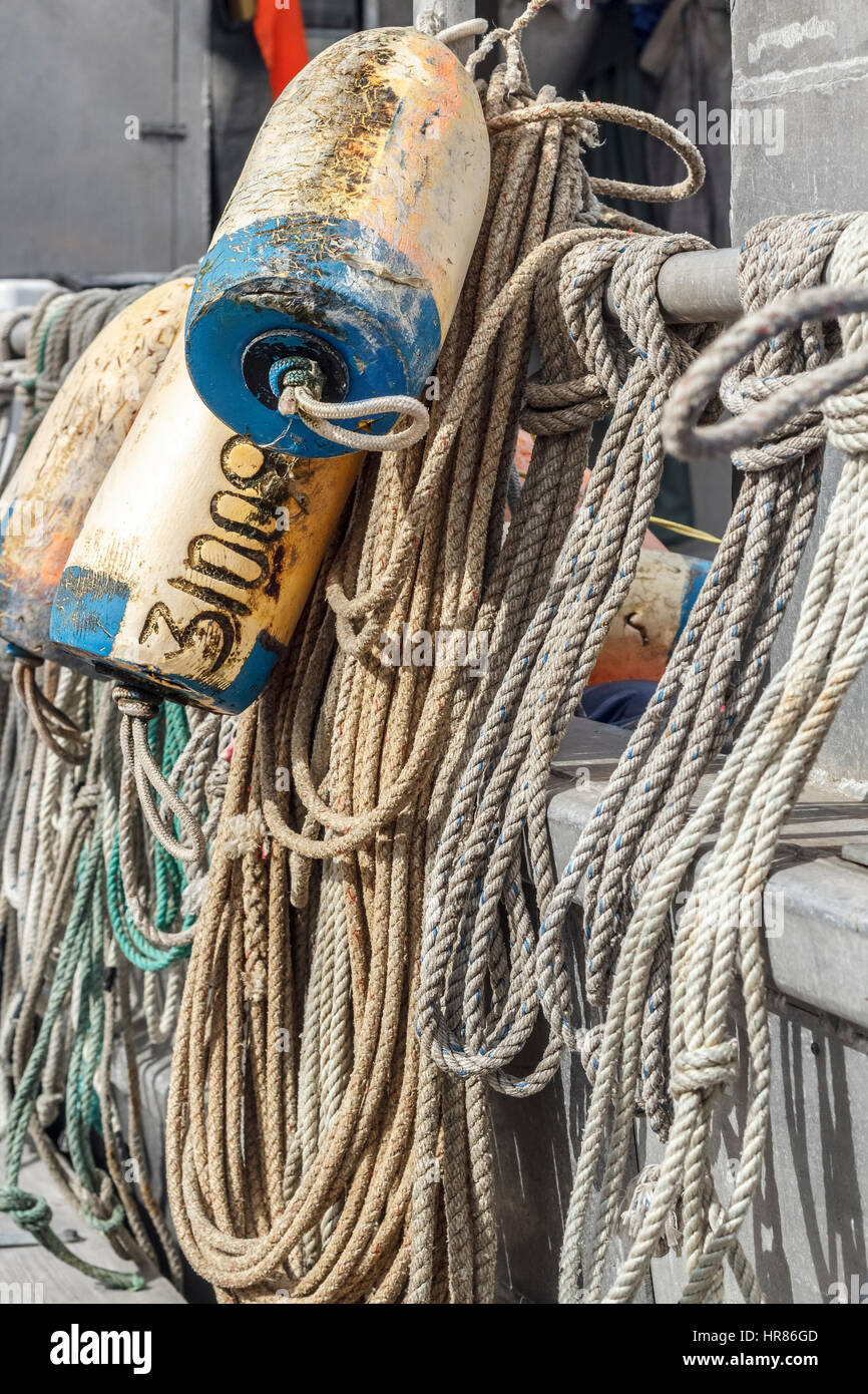 Ropes and fishing floats hang from the rail of a commercial fishing boat on Canada's west coast. Stock Photo