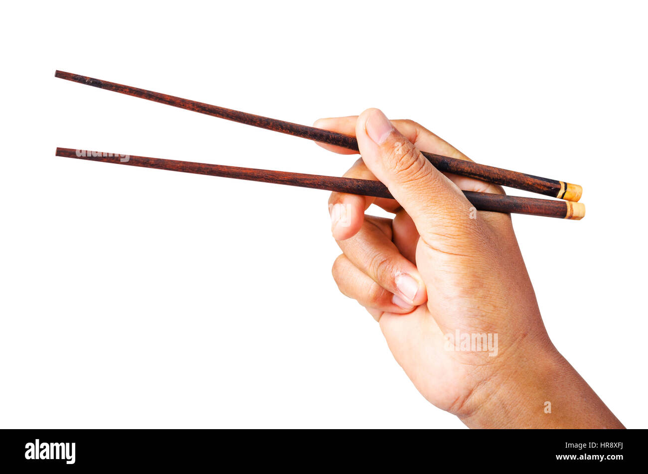 Person 's right hand using bamboo chopsticks isolated on white background, Saved clipping path. Stock Photo