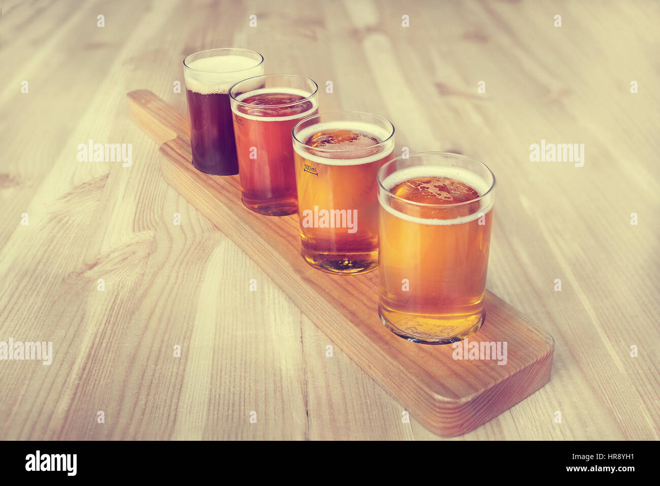 Beer tasting. Diferent beer in 100 mililiter glases over wooden table. Stock Photo