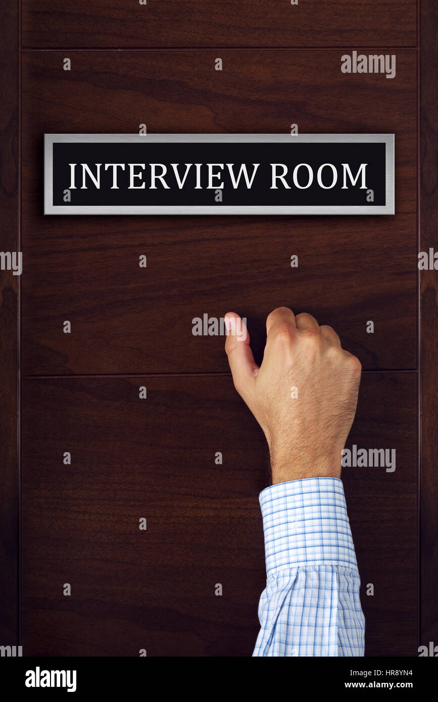 Businessman knocking on interview room door, man applying for a job, career opportunity concept Stock Photo