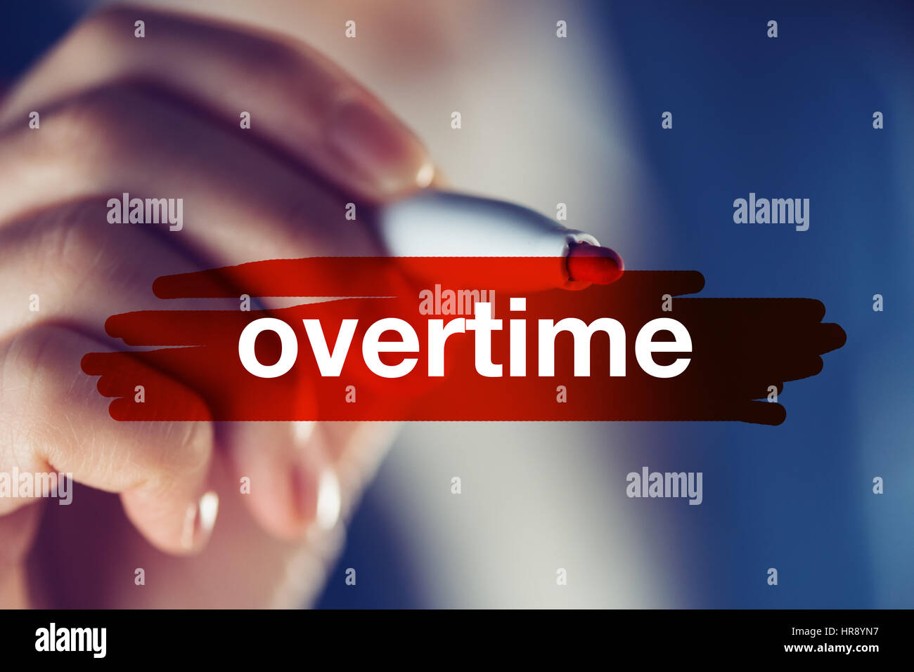 Overtime business concept, businesswoman highlighting word with red marker pen Stock Photo