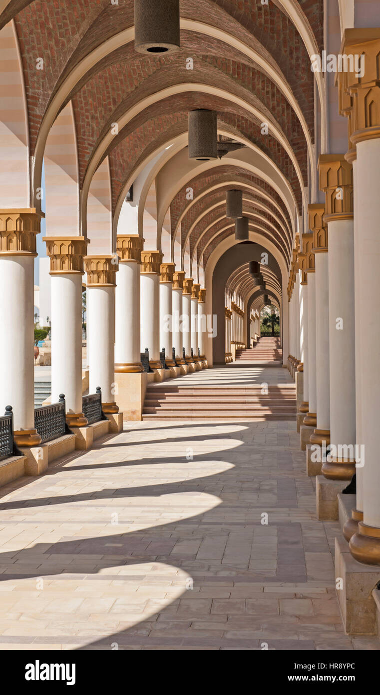 Corridor of arches diminishing to vanishing point at infinity abstract architecture Stock Photo