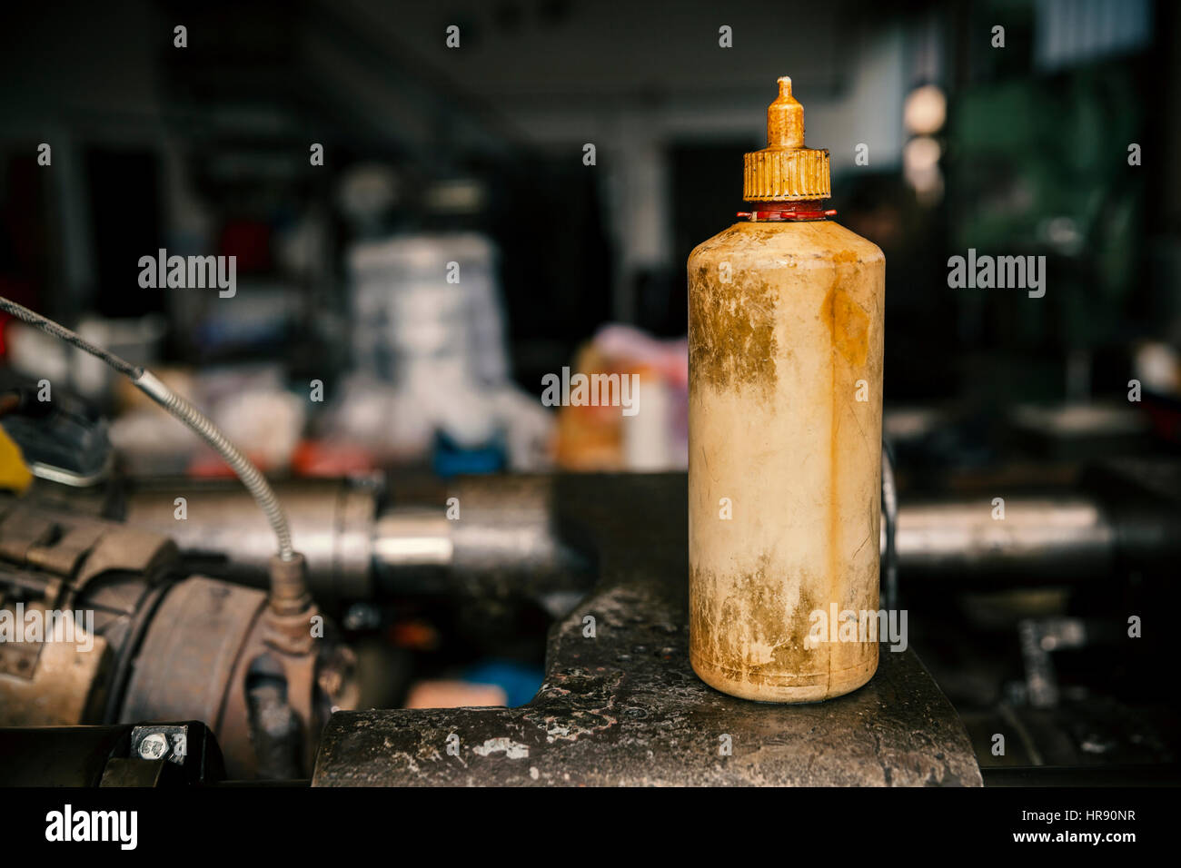 old plastic bottles for oil in the mechanical workshop Stock Photo