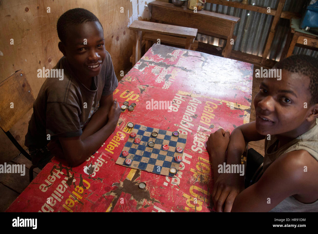 Two boys play board games in the orphanage, kibera slums, nairobi