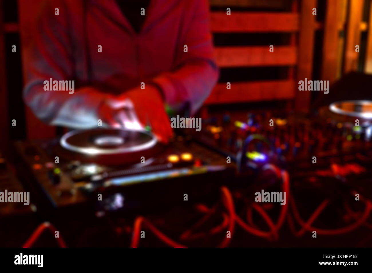 Blurred background of a DJ playing music in a party Stock Photo - Alamy