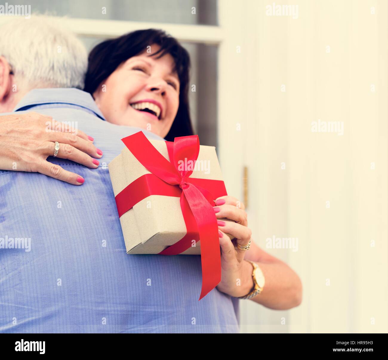 Wife hugging husband for the present Stock Photo - Alamy