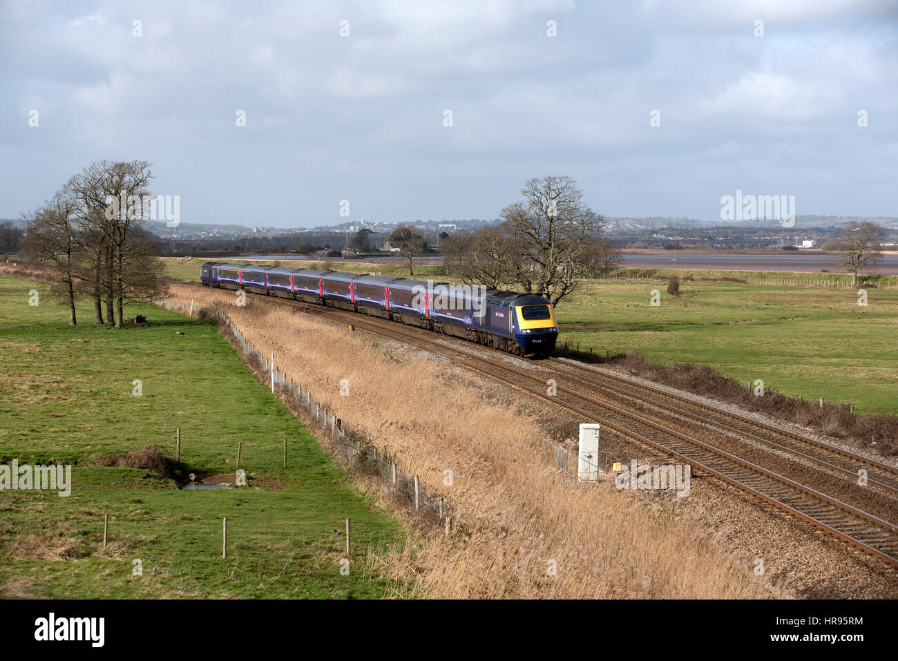 A First Great Western company passenger train passing through English countryside south of Exeter in Devon UK Stock Photo