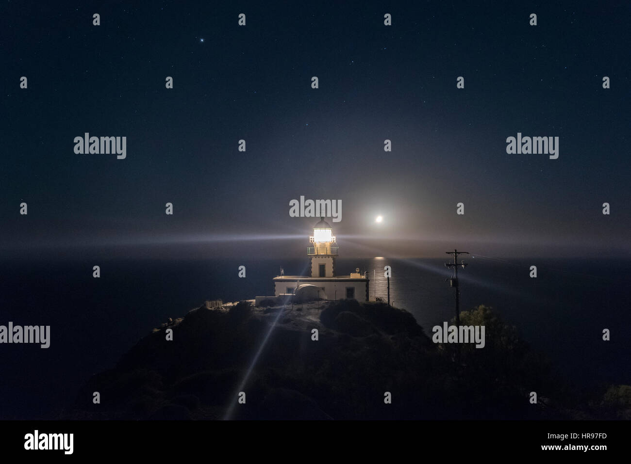Santorini Moonlight Lighthouse Stock Photo