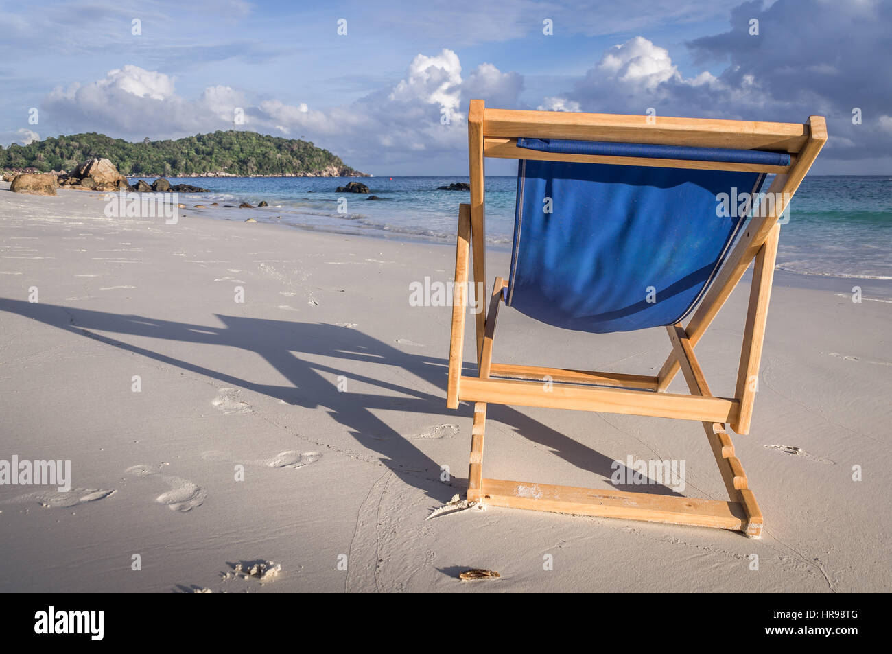 A blue deck chair invites to relax on this beautiful white beach in Ko Lipe, Thailand Stock Photo