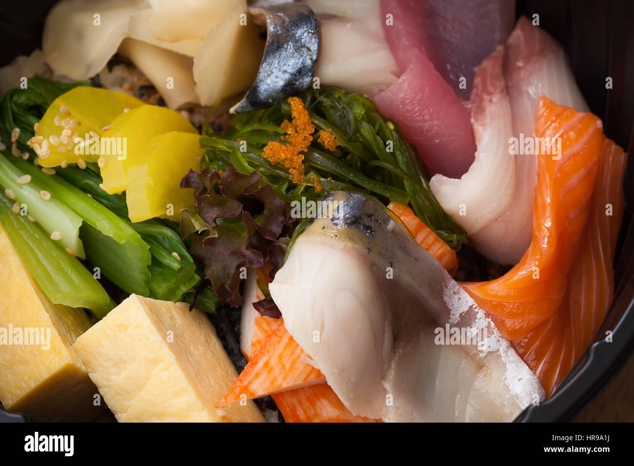 Japanese food Tekka Don take away on wooden background raw tuna salmon otoro seaweed rice Stock