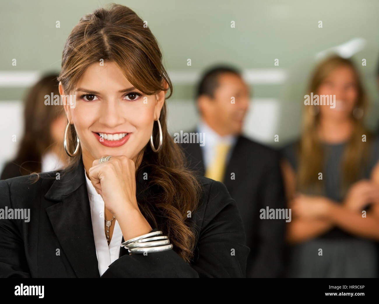 Business woman smiling leading a team during an office meeting Stock ...