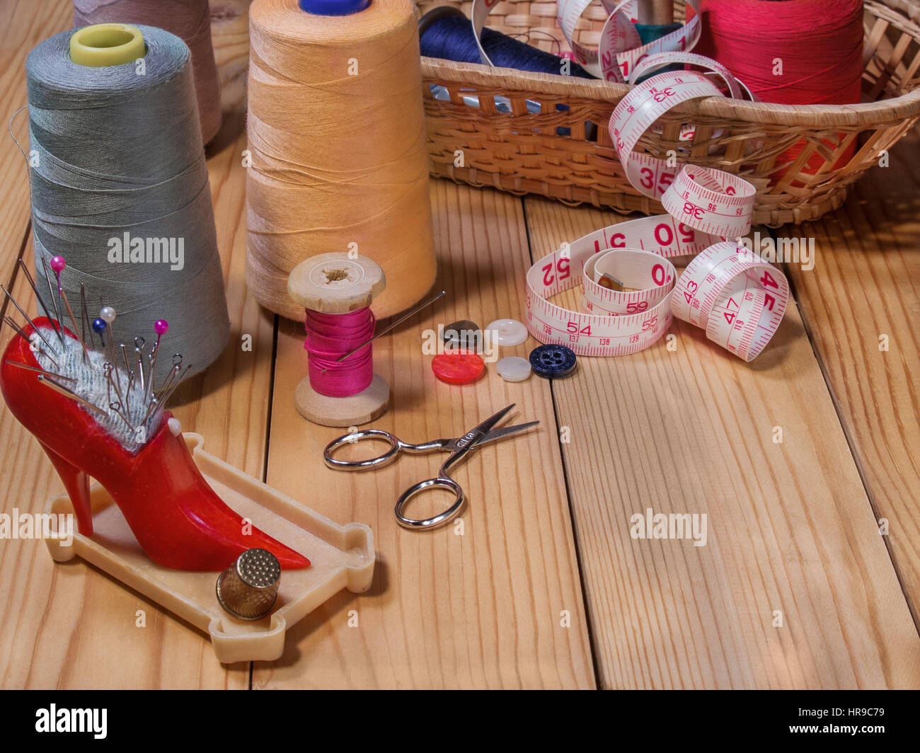 Needle bed with needles and pins, thread on a spool, thread on large