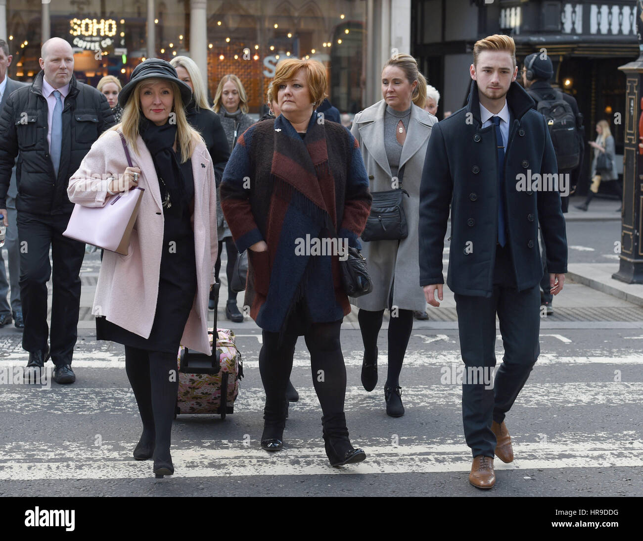 Owen Richards and his mother Suzanne Richards (centre) arriving at the Royal Courts of Justice in London as the coroner at the inquest into the deaths of 30 Britons killed by an extremist gunman in Tunisia is to deliver his conclusions. Stock Photo