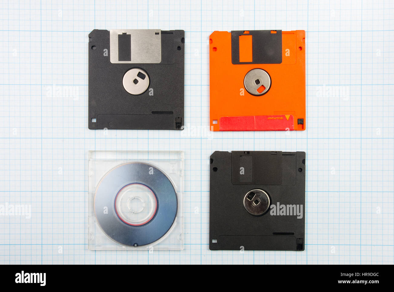 vintage background - computer floppy disks and mini-CD on the blueprint paper, toned Stock Photo