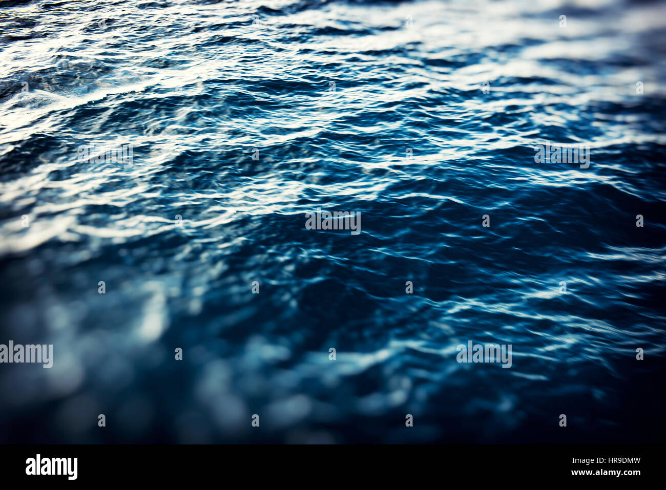 Blurred beautiful abstract dark blue ocean background with lights. blurry wallpaper concept. Stock Photo