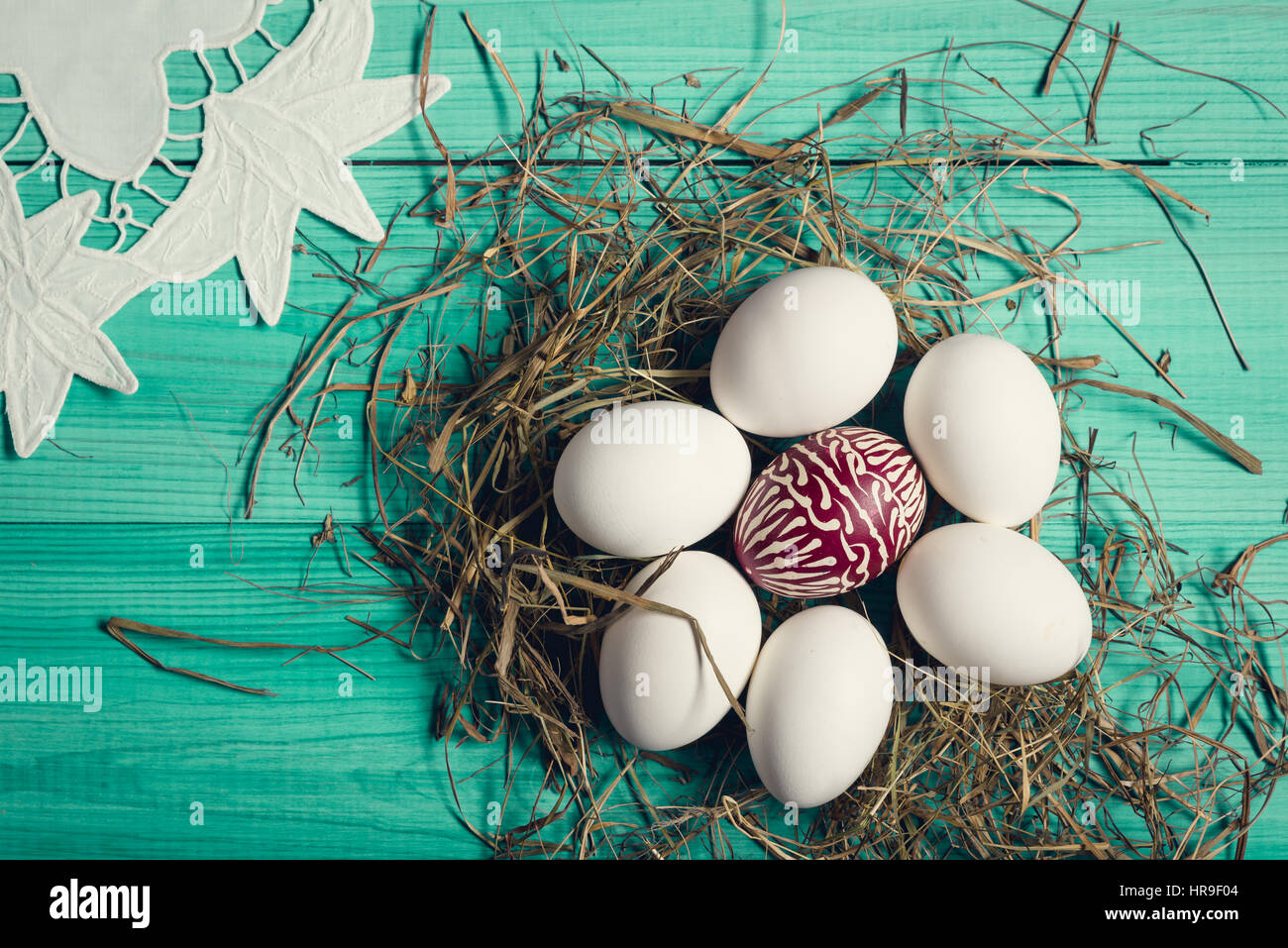 Group of easter eggs on the green wooden surface. Easter concept. Stock Photo