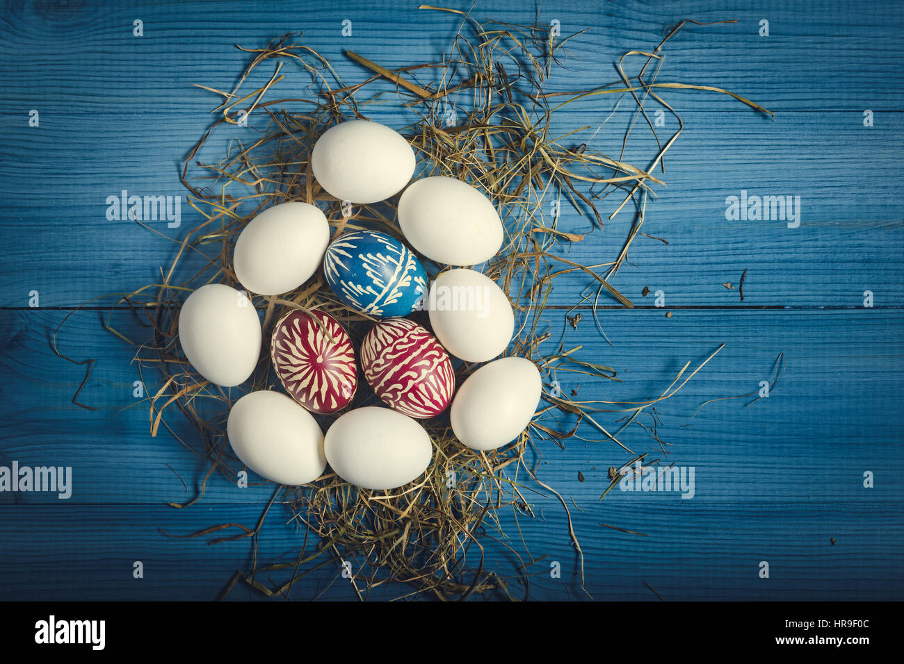 Group of easter eggs on the blue wooden surface. Easter concept. Stock Photo