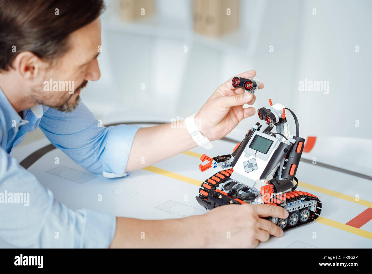Pleasant engineer testing the robot Stock Photo - Alamy