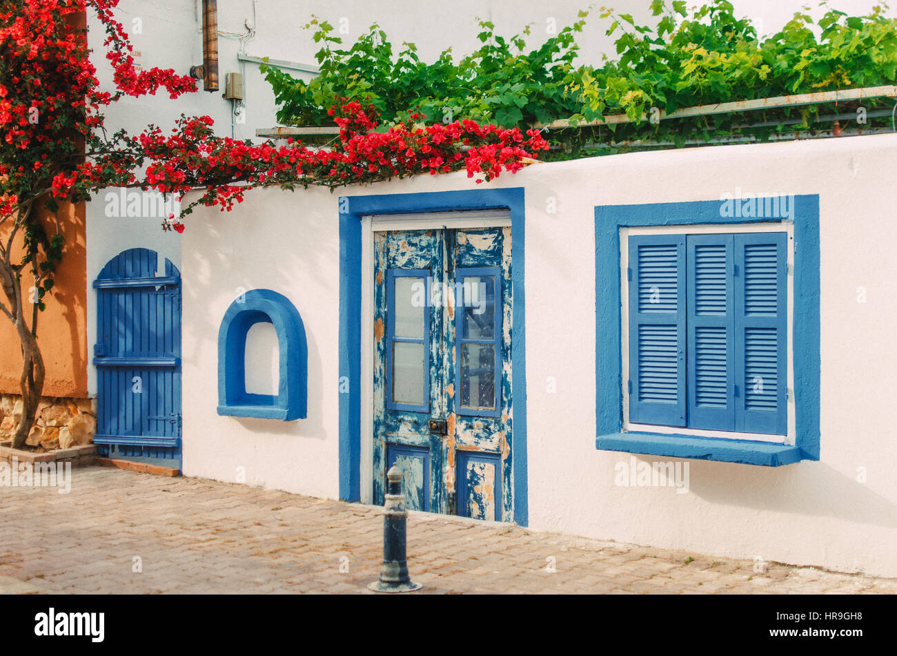 Facade Of A Very Small White House With Blue Windows In Halkidiki