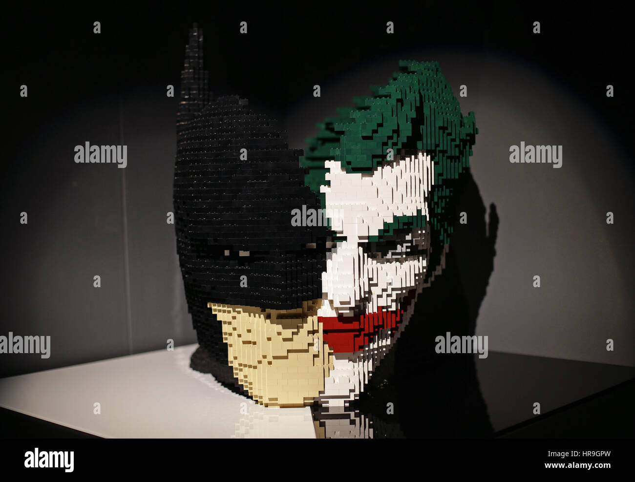 A model of Batman and The Joker's face intertwined on display, during ...