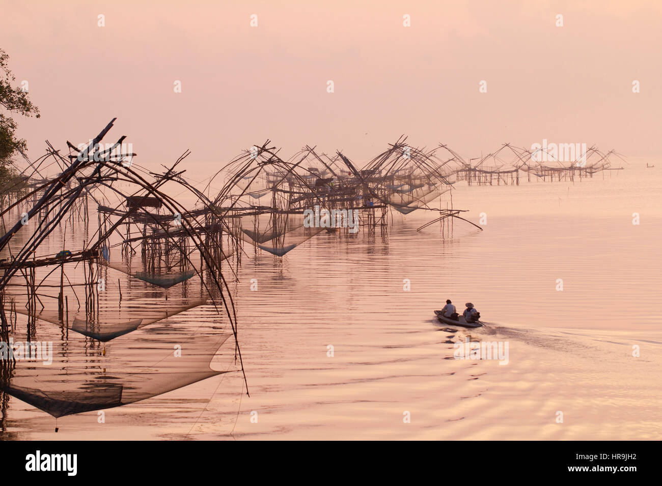 Fishing nets in the lake in Southern part of Thailand in warm morning light Stock Photo