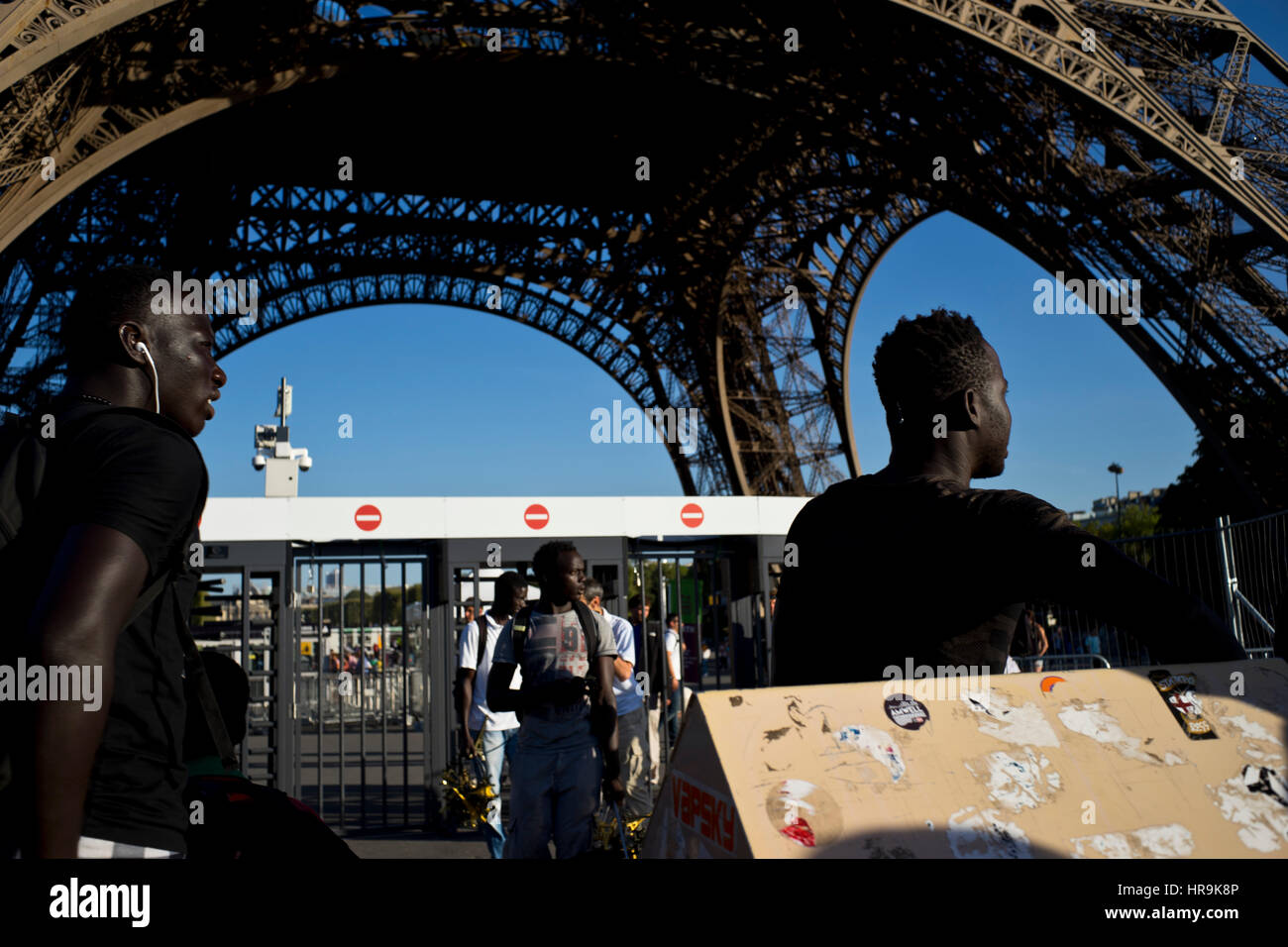 refugees and migrants from africa in front of eiffel tower in Paris Stock Photo
