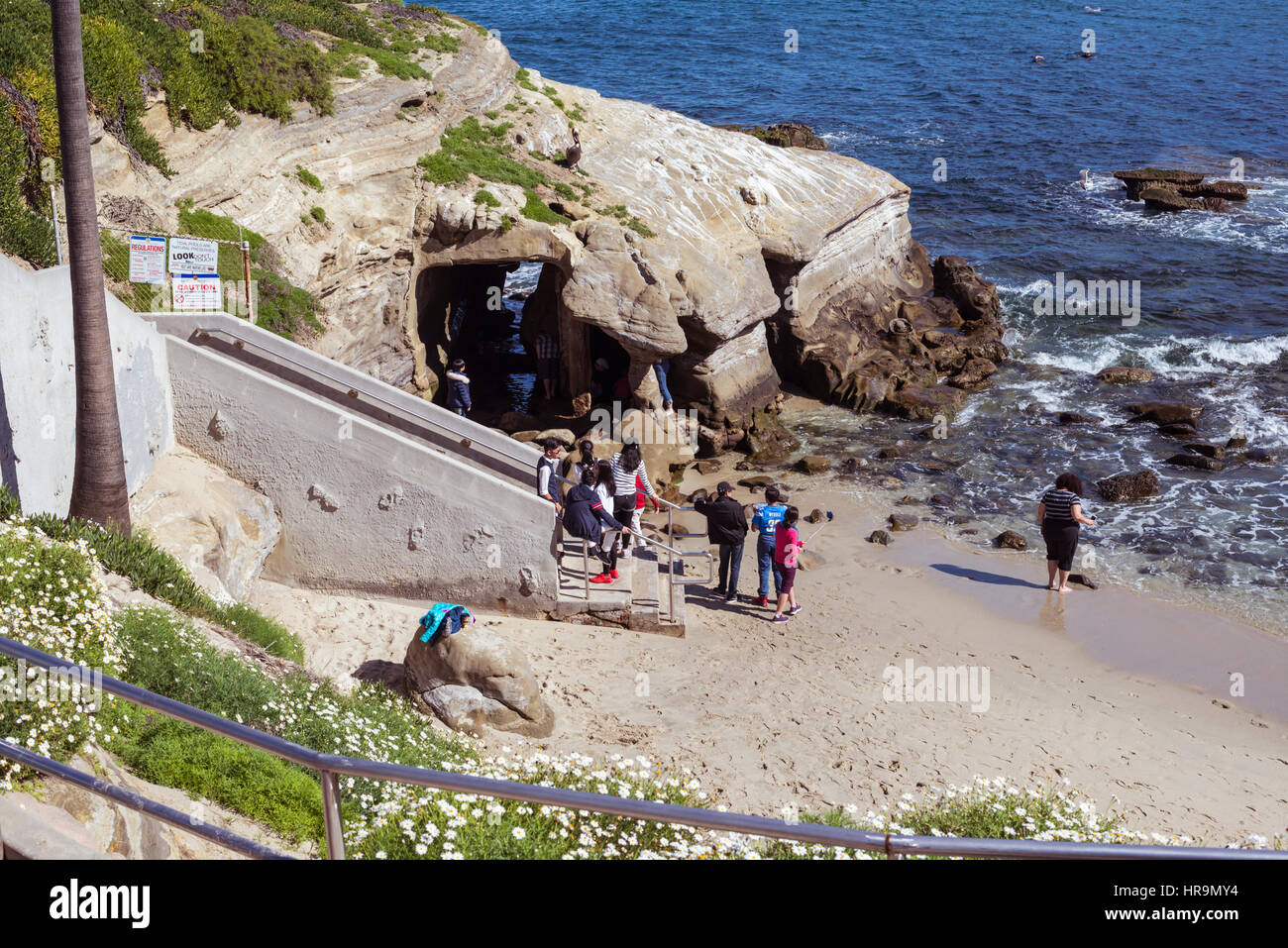 People entering a sea cave at the La Jolla Cove Beach. La Jolla, California. Stock Photo