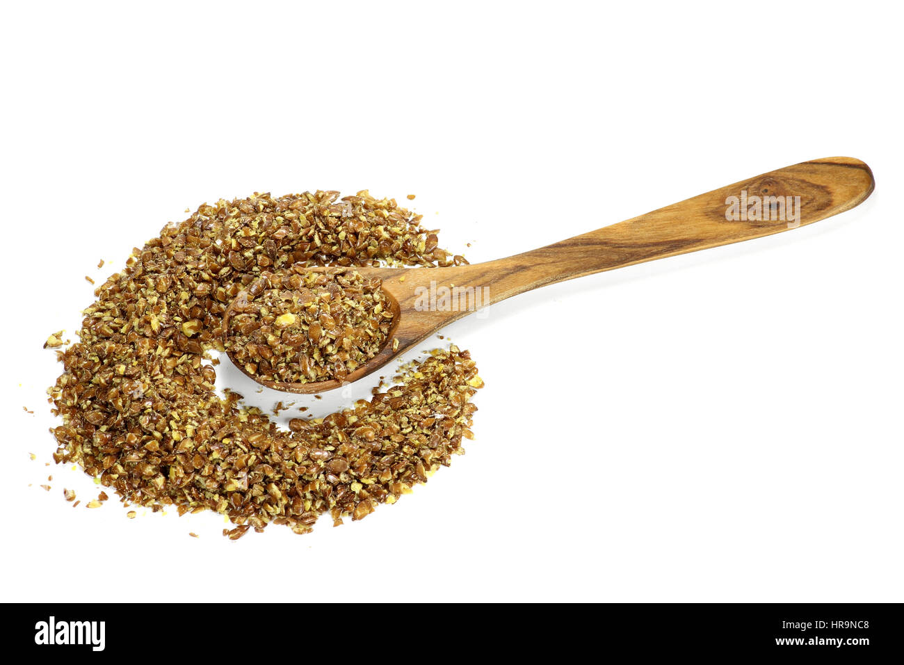 wooden spoon with flaxseed grist isolated on white background Stock Photo