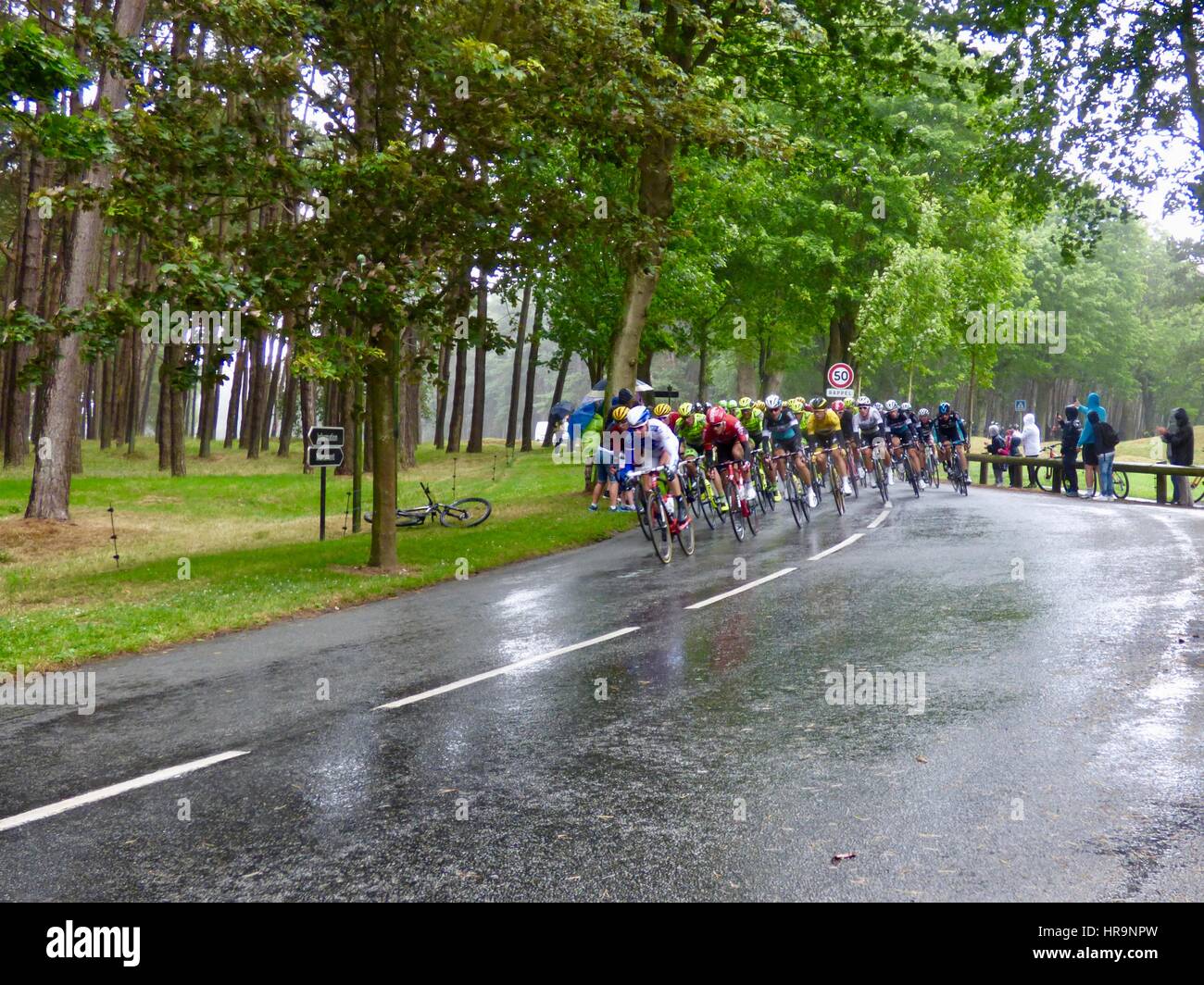 Tour de France 2015, Stage 5, peloton fights to keep on track during heavy rain on the route through Vimy Ridge, Canadian WWI Memorial, France. Stock Photo