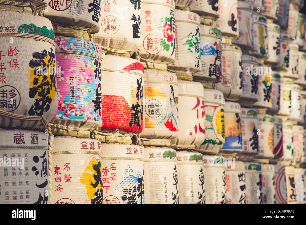 TOKYO, JAPAN - MARCH 30: A collection of Japanese sake barrels stacked is at the Japanese Meiji Shrine. Stock Photo