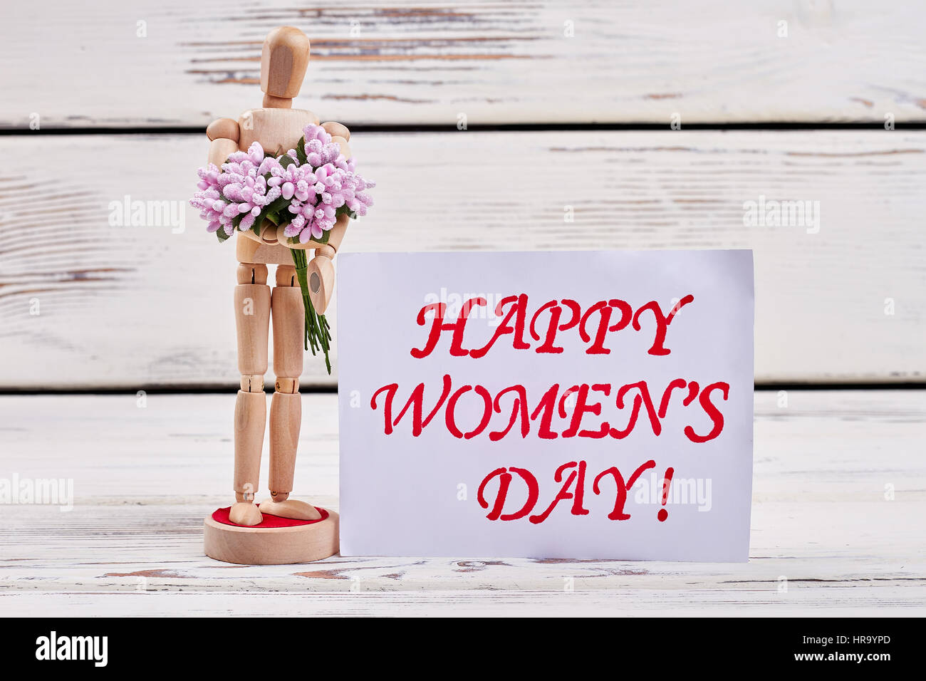 Wooden mannequin and greeting card. Stock Photo