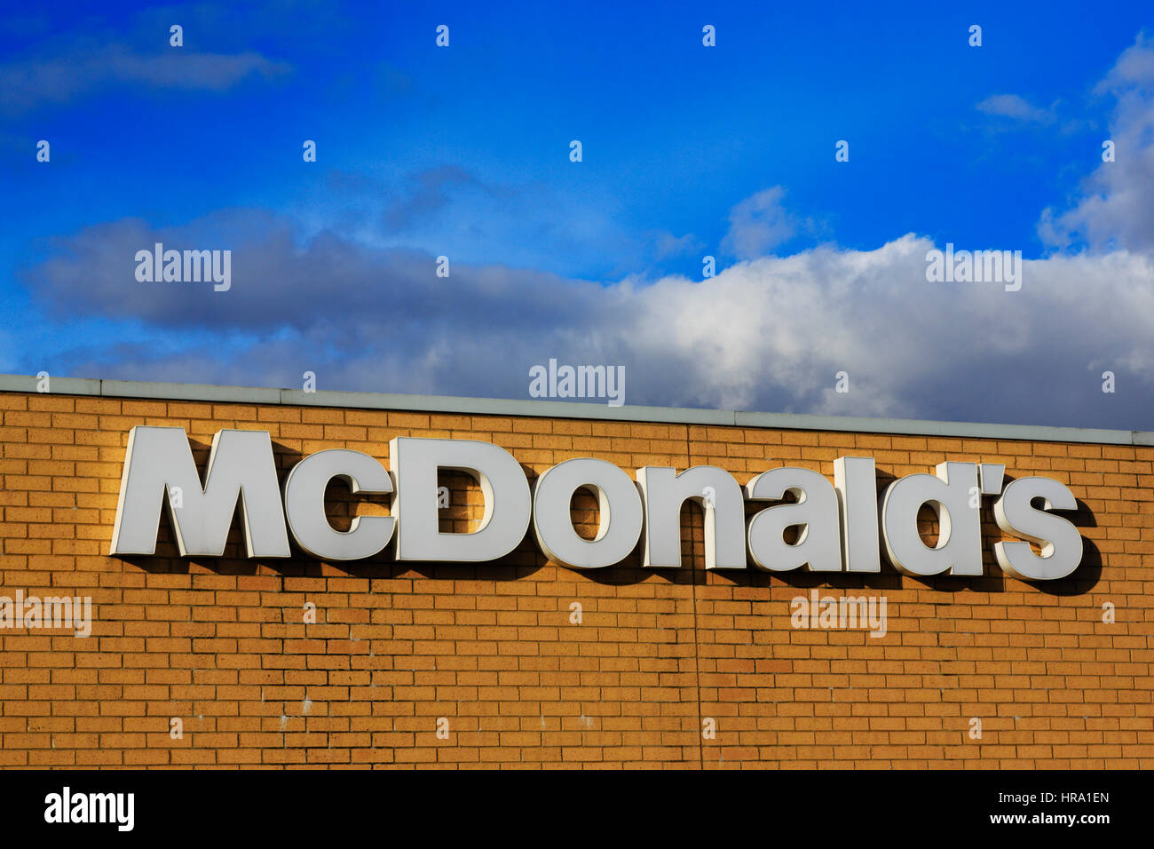 'McDonald's sign on brick wall, Solstice Park, Amesbury, Wiltshire, England Stock Photo