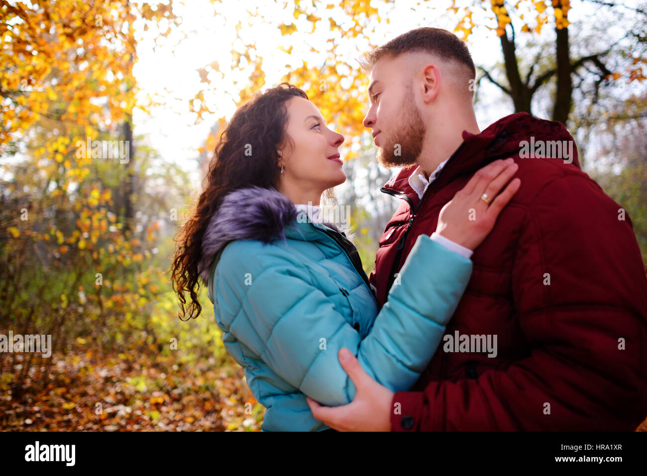 Portrait of young loving couple kissing in autumn park Stock Photo - Alamy