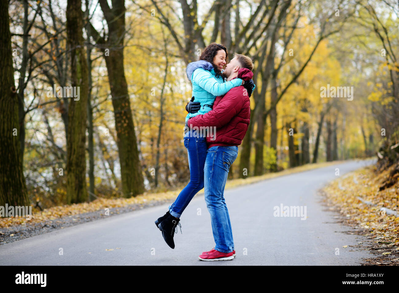 Portrait of young loving couple kissing in autumn park Stock Photo - Alamy