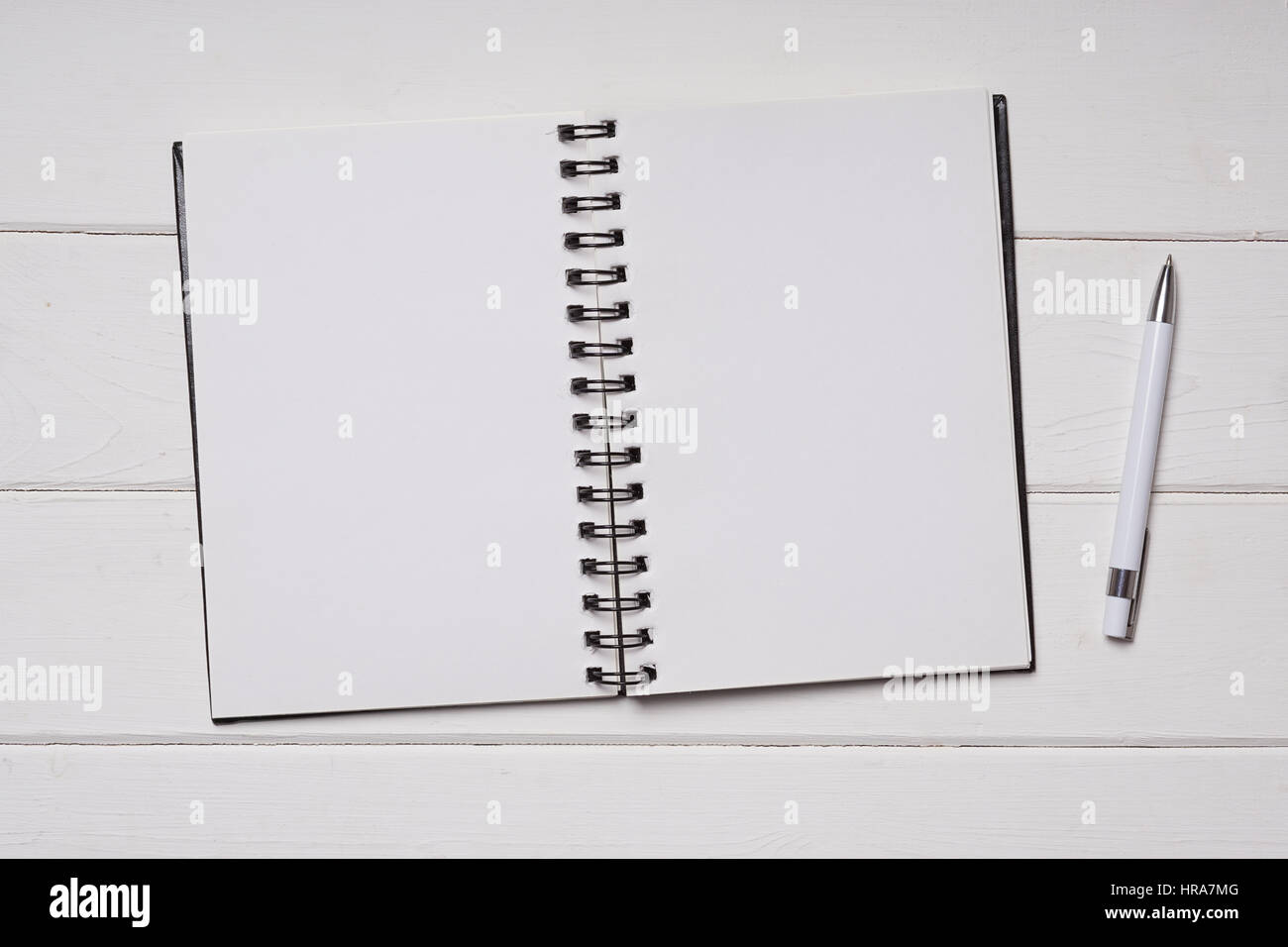 notebook and pen on white wooden desk Stock Photo