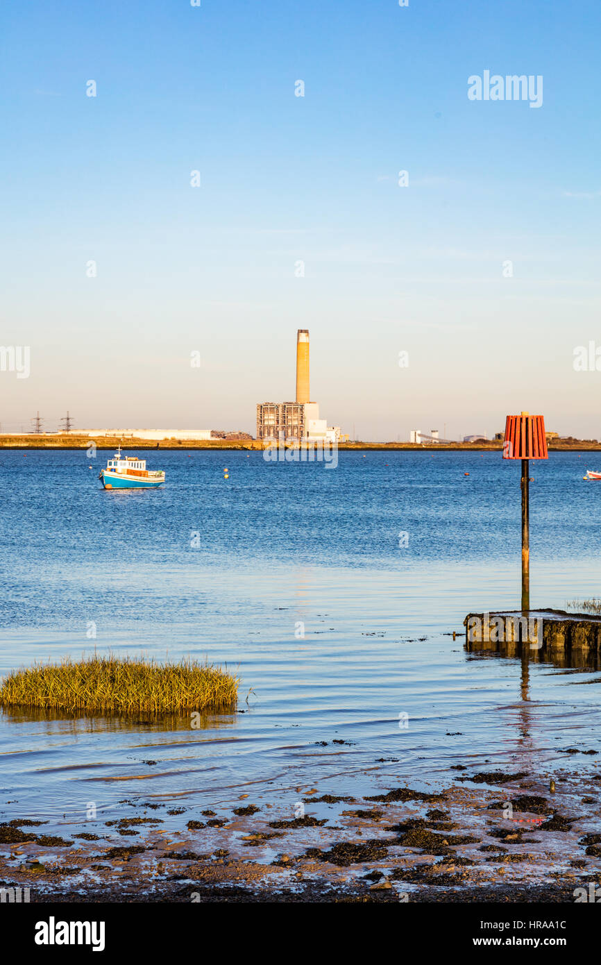 Isle of Grain power station in the distance, in the winter haze and mist, across the River Medway, seen from The Strand, Gillingham, Kent, UK Stock Photo