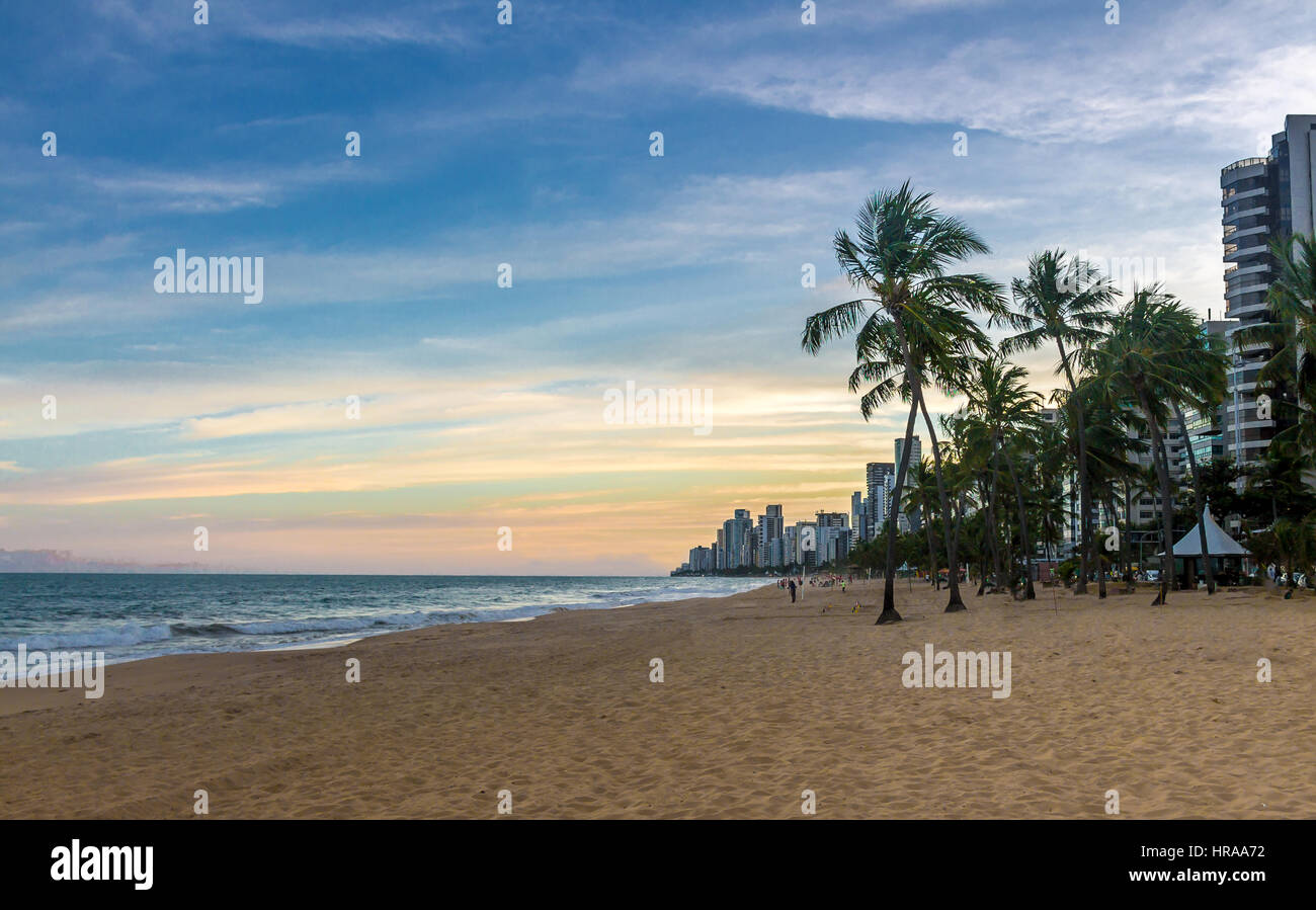 Sunset at a Boa Viagem beach with palm trees - Recife, Brazil Stock Photo
