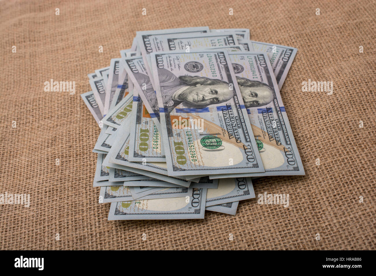 Banknote bundle of US dollar placed on a linen canvas Stock Photo - Alamy