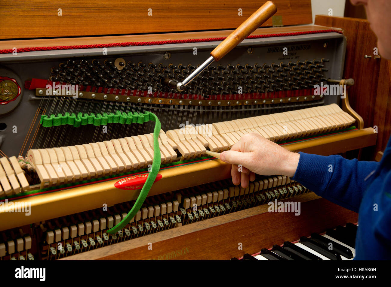 A piano tuner tuning an upright piano, London, UK Stock Photo - Alamy