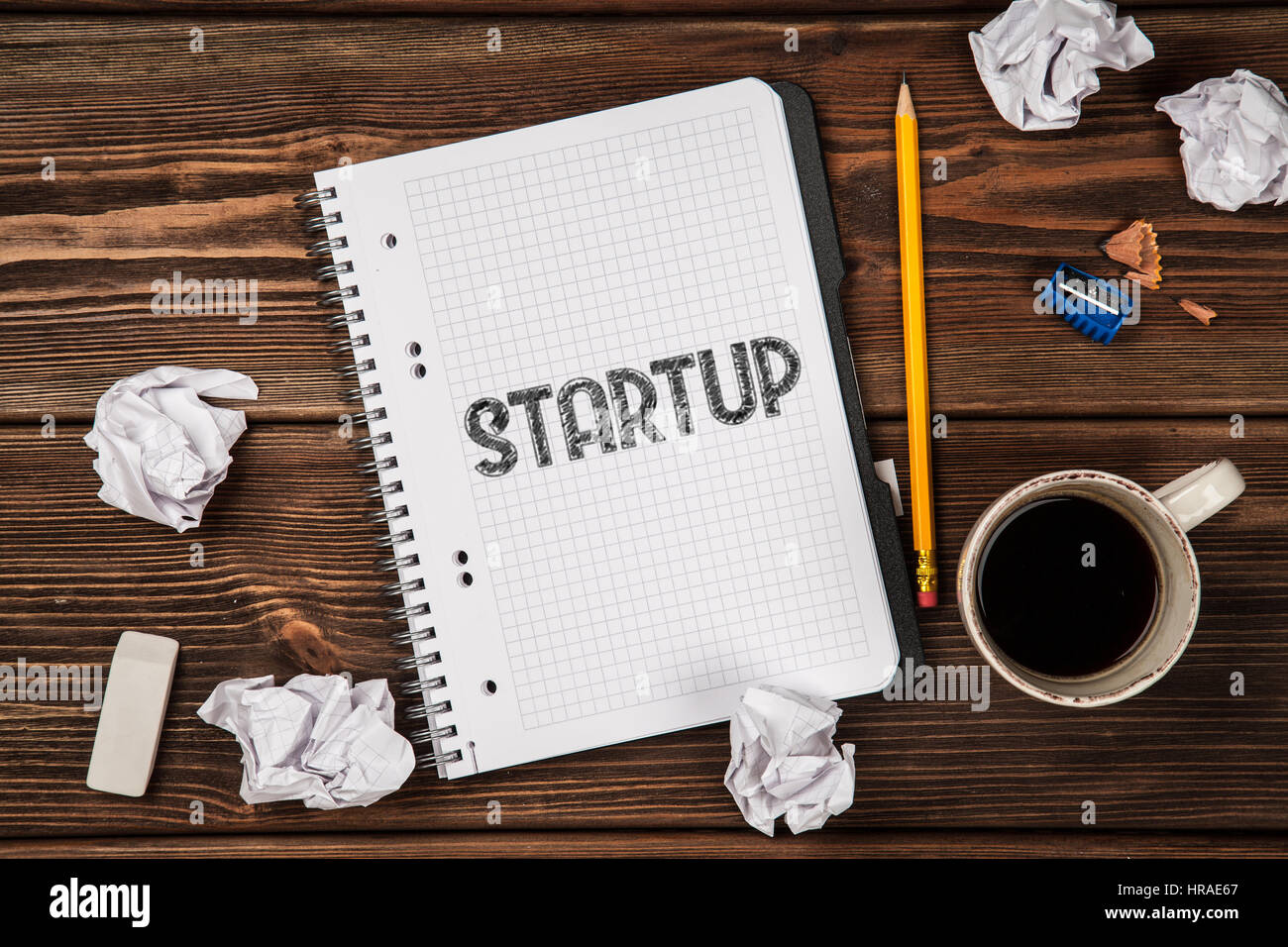 Open notepad with Startup sign Stock Photo