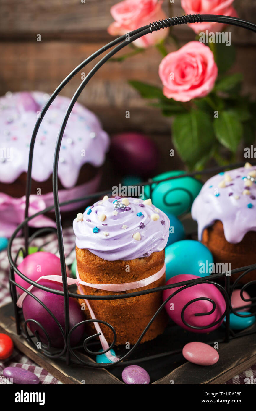 Delicious homemade holiday Easter cakes and colored eggs around Stock Photo