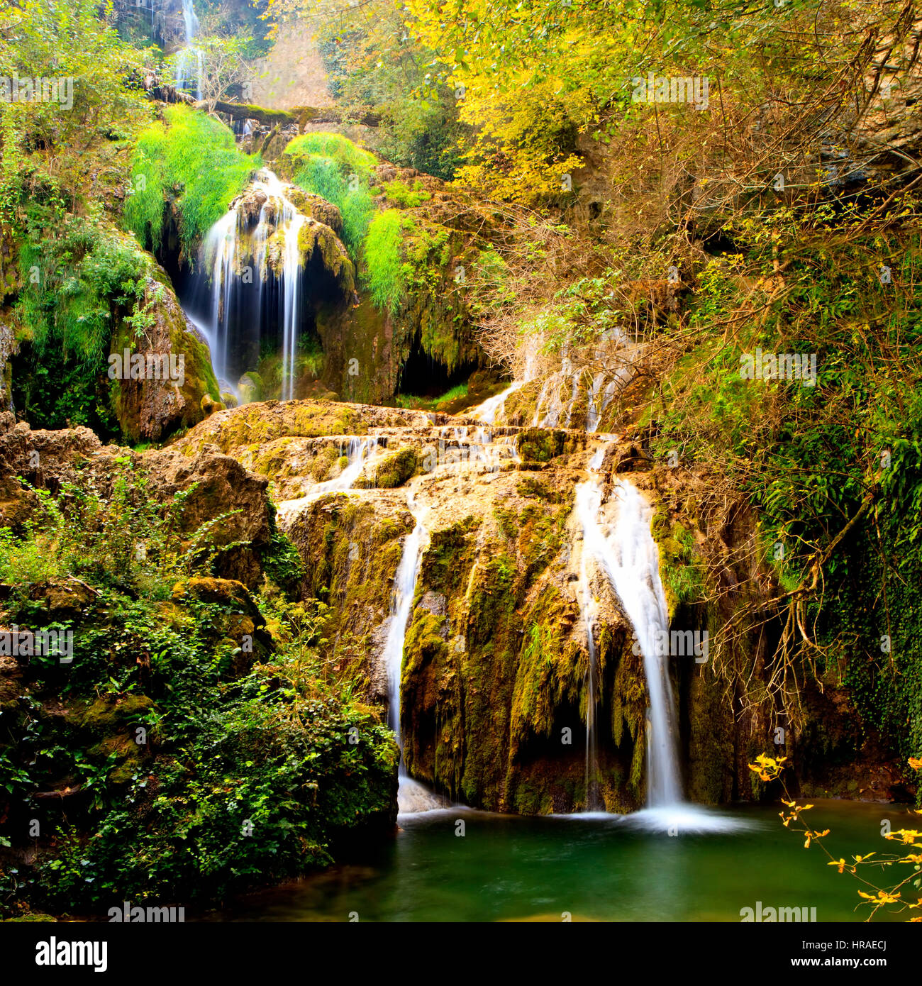 magestic autumn in the forest, cristal clear blue water and cascade ...