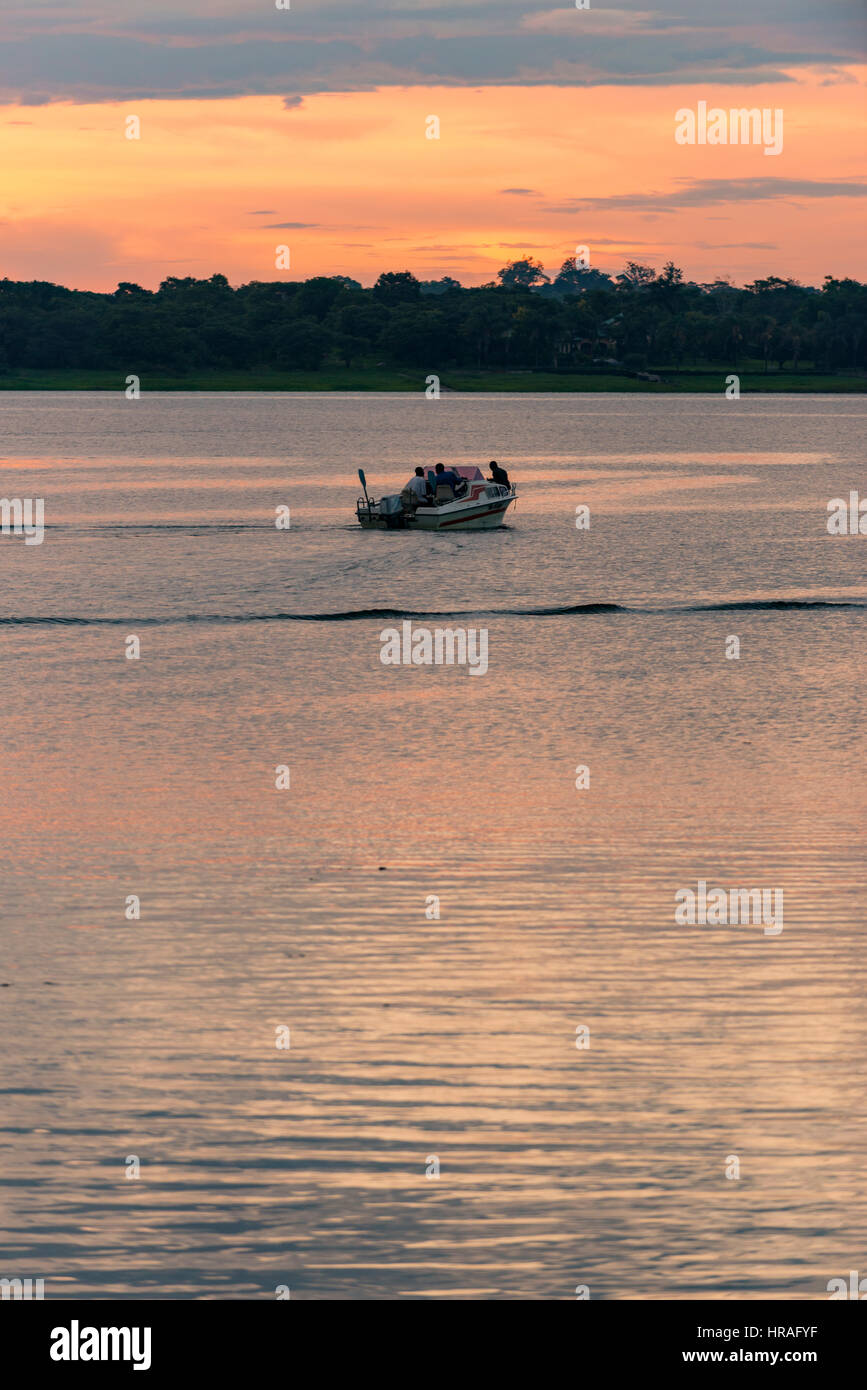 A speedboat enjoys a sunset cruise, Zimbabwe Stock Photo