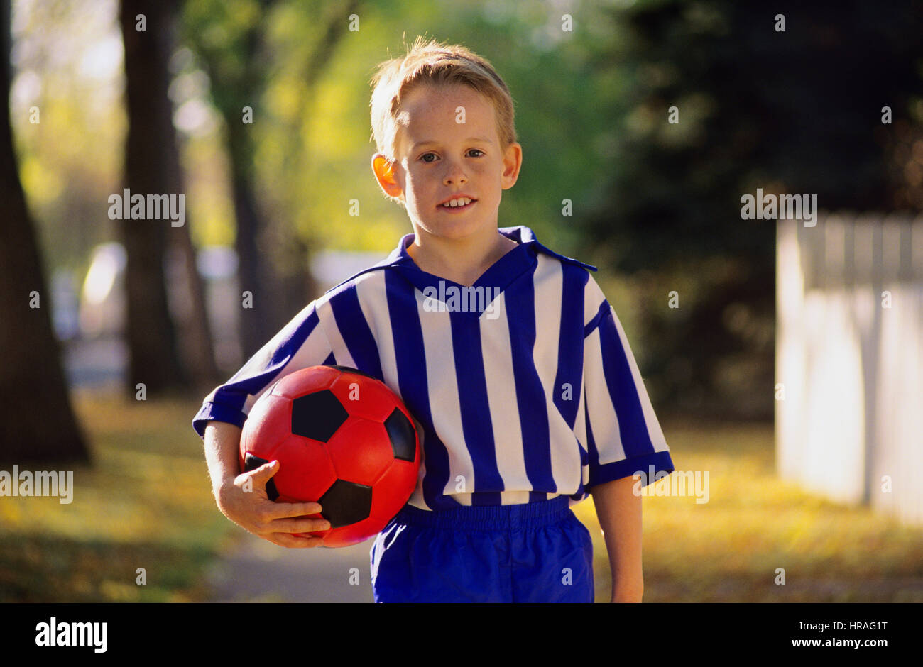 Boy Wearing a Soccer Uniform Holding a Soccer Ball Stock Photo Alamy