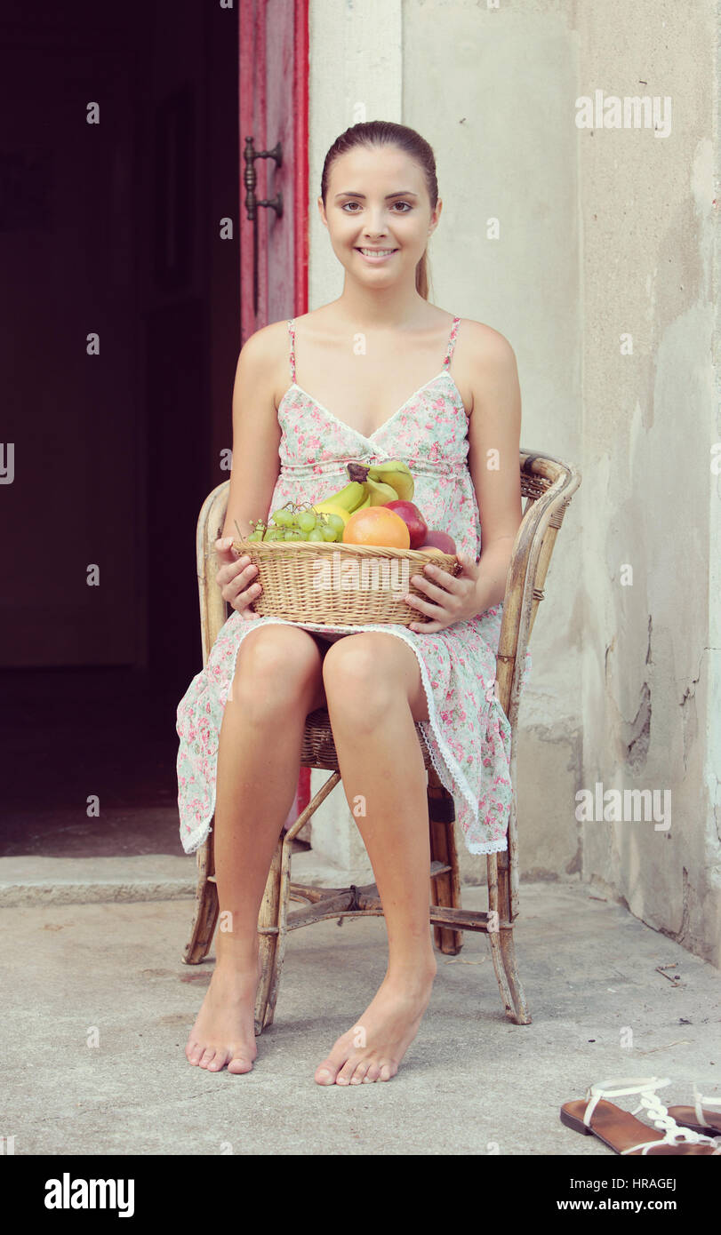 Portrait of eautiful girl with a basket of fresh fruit Stock Photo